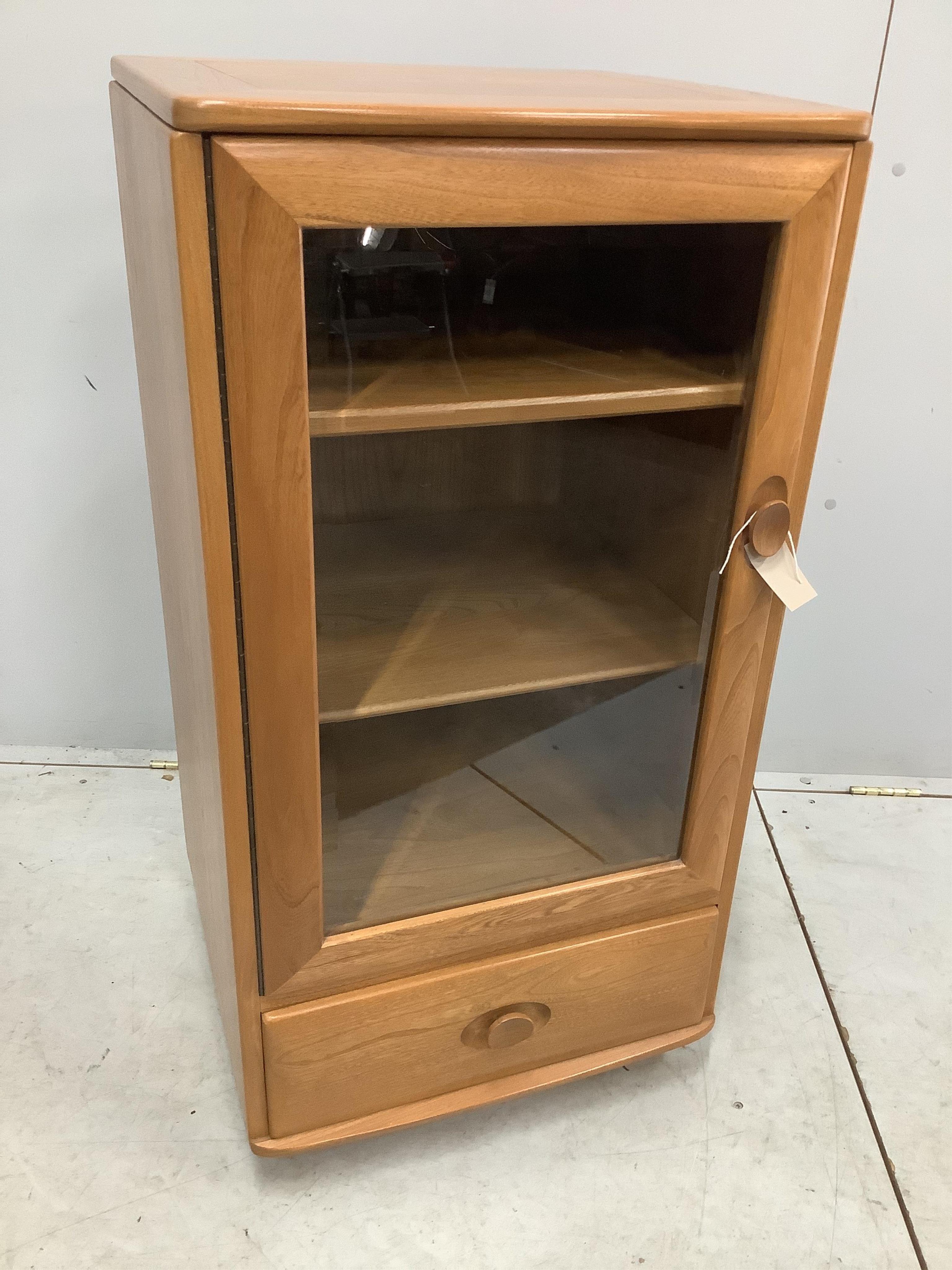 An Ercol Windsor elm Hi-Fi unit, width 50cm, depth 47cm, height 98cm. Condition - good